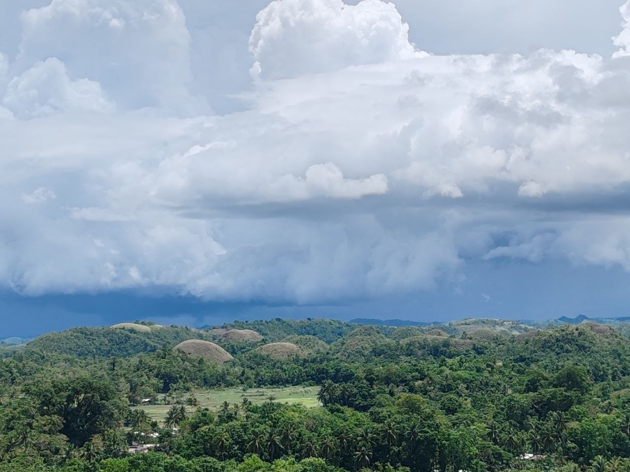 Chocolate Hills under storm clouds